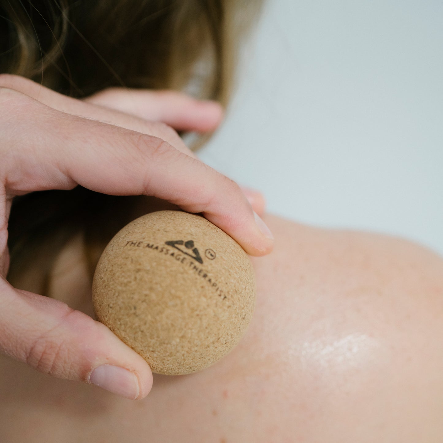 Using the cork massage ball to ease oak  and muscle tension in the shoulders