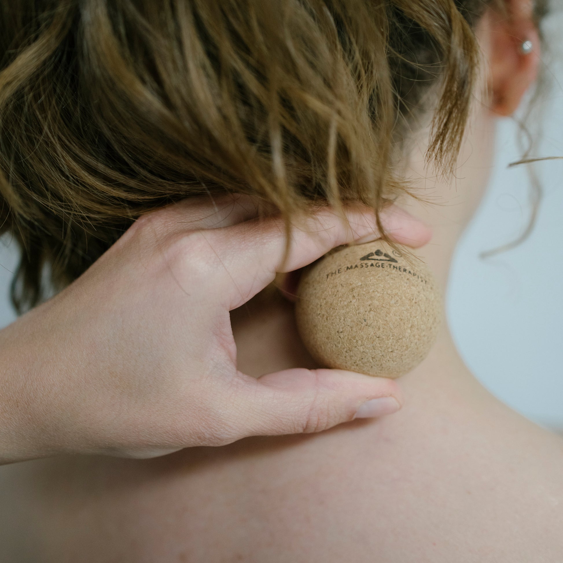 Using the cork massage ball to ease pain and muscle tension in the neck.