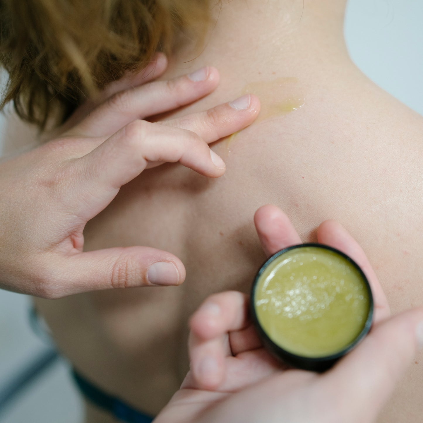  CBD massage Balm being used on shoulder for a sports injury